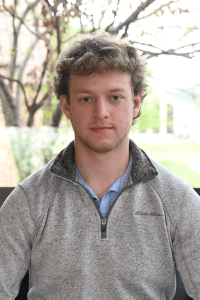 Employee Headshot in front of a tree